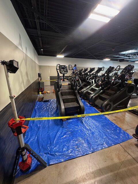 Fitness equipment service project showing stair climber inspection for gym owners in a commercial facility