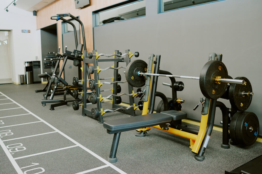 Spacious modern zone for pumping iron, zone equipped with bars plates benchSpacious modern zone for pumping iron, zone equipped with more gym equipment